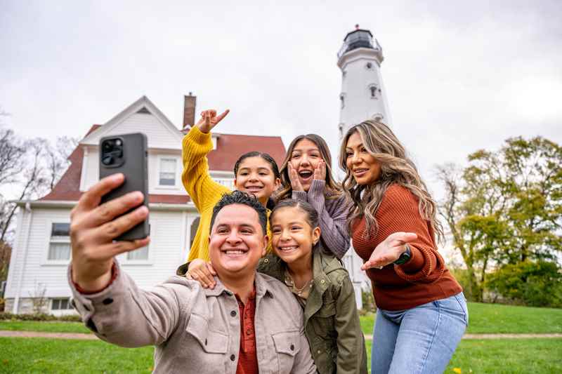 family posing for a selfie at northpoint lighthouse in milwaukee, wisconsin