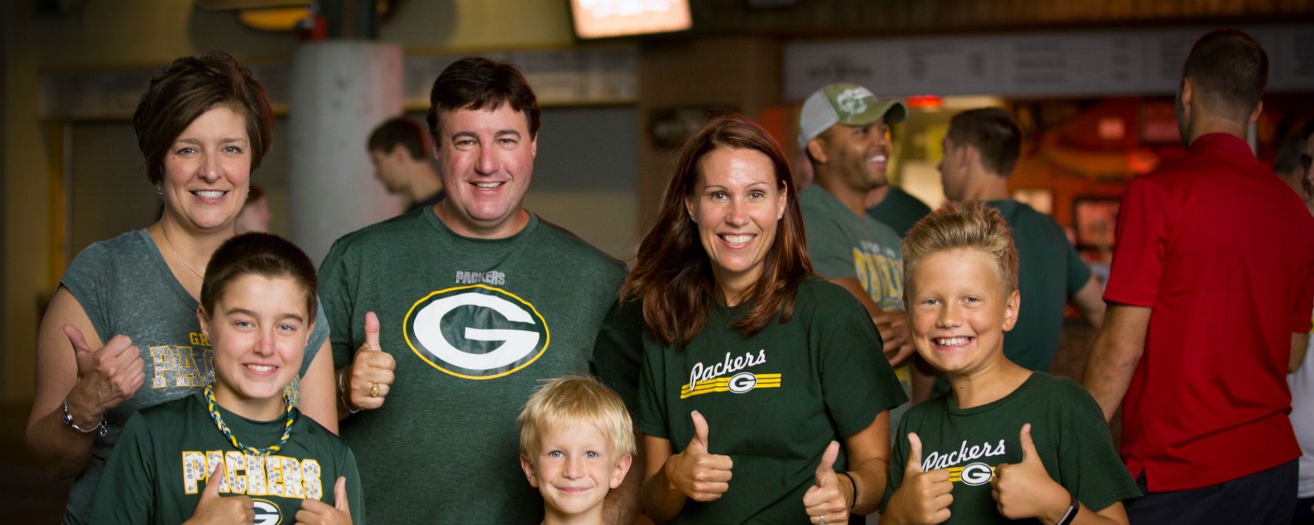Packers Fans Giving Thumbs Up in Lambeau Field Atrium