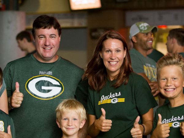 Packers Fans Giving Thumbs Up in Lambeau Field Atrium