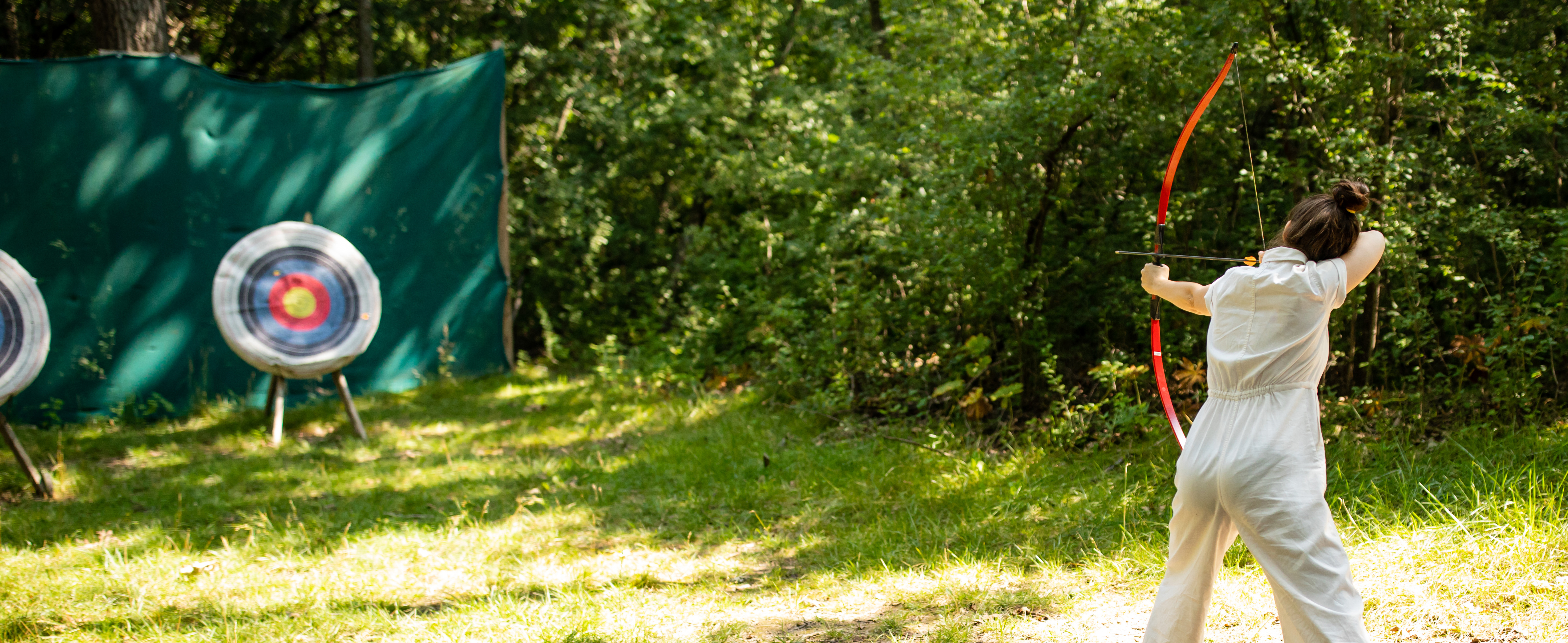 Woman Shooting bow and arrow at Camp Wandawega