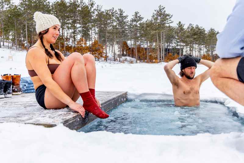 woman prepares to enter a cold water plunge