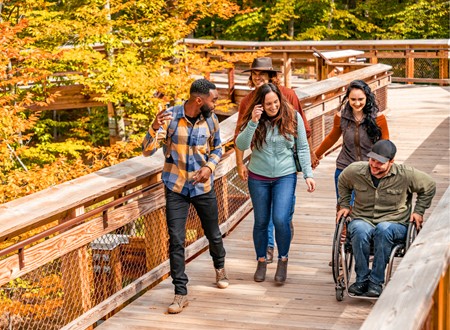 friends walking on accessible pathway up observation tower loading=
