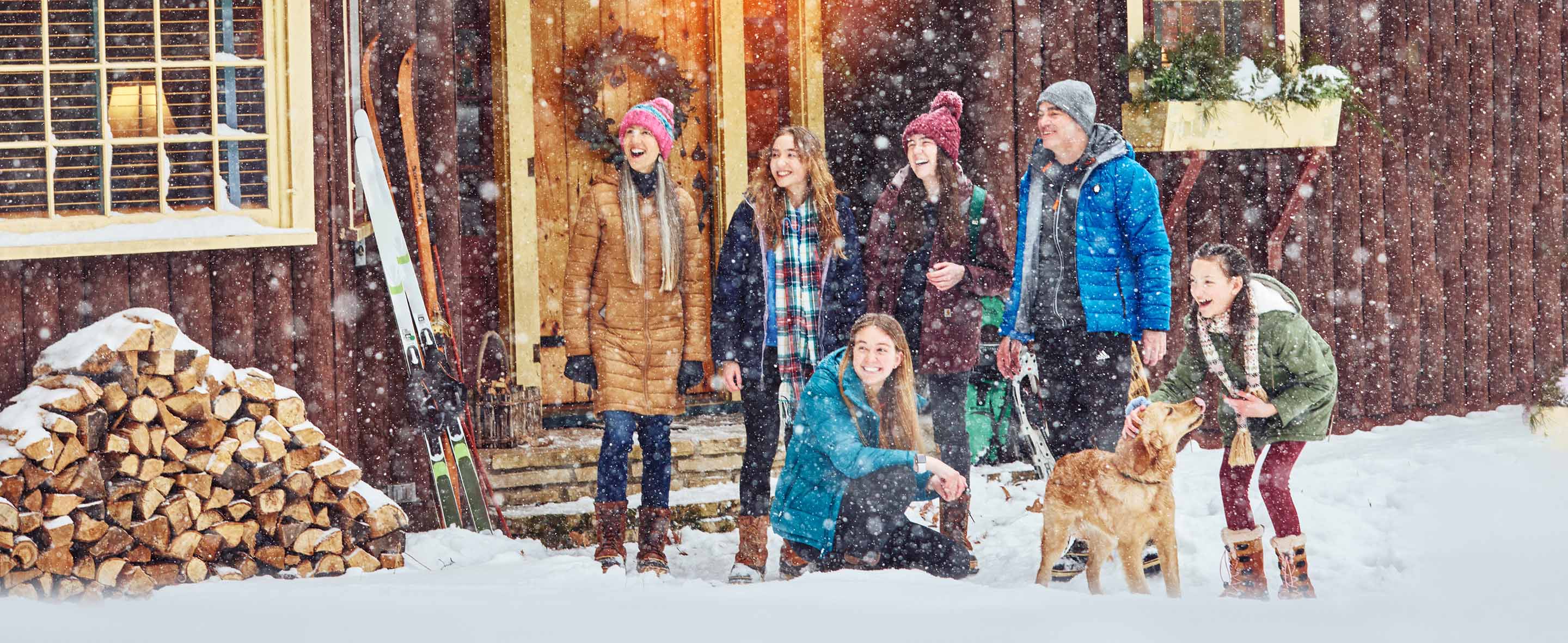 082 Family Watches Snowfall Outside a Cabin