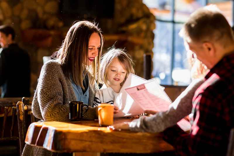 Family looking through menus at a restaurant