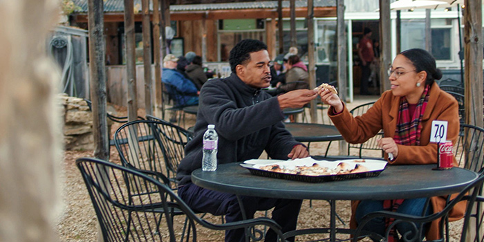 Couple eating a meal on an outdoor patio