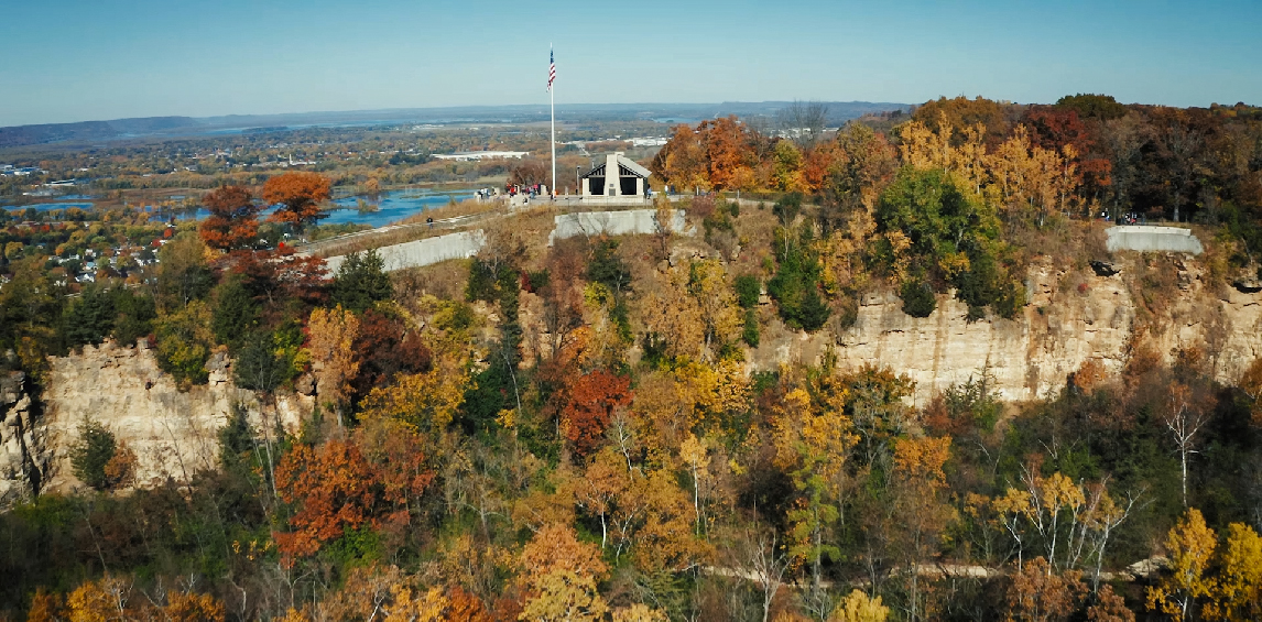 Bird's-eye view of a town full of trees with fall colors