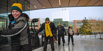 People ice skating on an urban skating rink