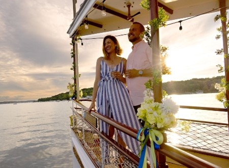couple enjoys a sunset cruise on a historic wooden steam engine boat on lake geneva loading=