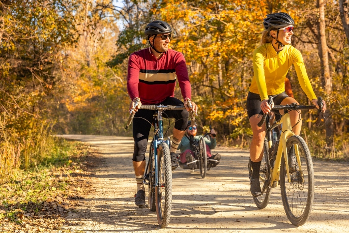 Man And Woman Biking Together On Fall Trail In Pepin County