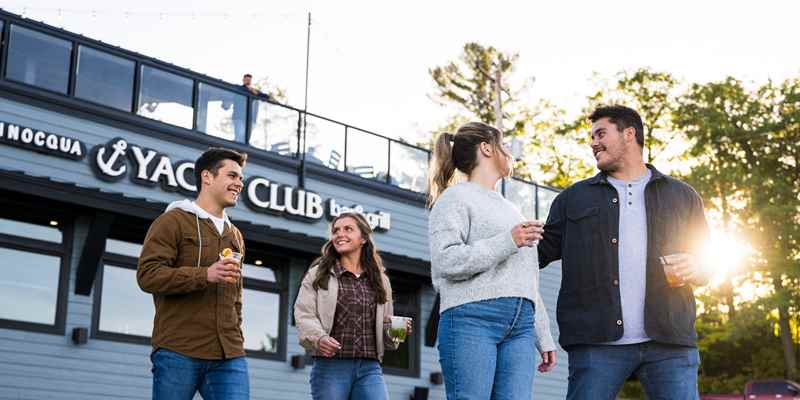 friends enjoying a beverage outdoors at the minocqua yacht club