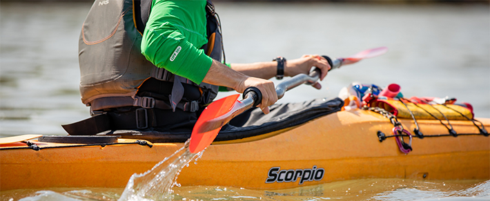 Man in a yellow kayak at the Apostle Islands in Bayfield