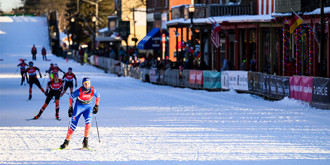 Long snow covered track with cross country skiers racing