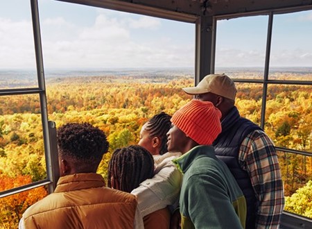 family viewing fall colors from a tower loading=
