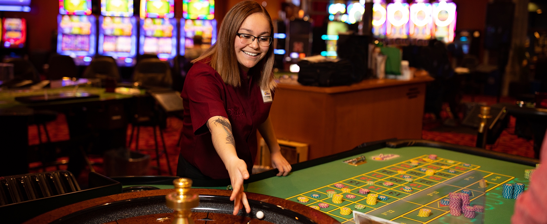 A roulette dealer spinning the wheel