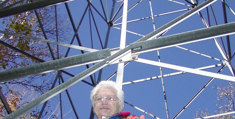 Betty stands by the fire tower that she worked for several seasons in the 1940s. Check out the site's interpretive signs to learn her story.