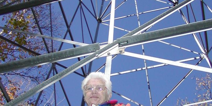 Betty stands by the fire tower that she worked for several seasons in the 1940s. Check out the site&#39;s interpretive signs to learn her story.