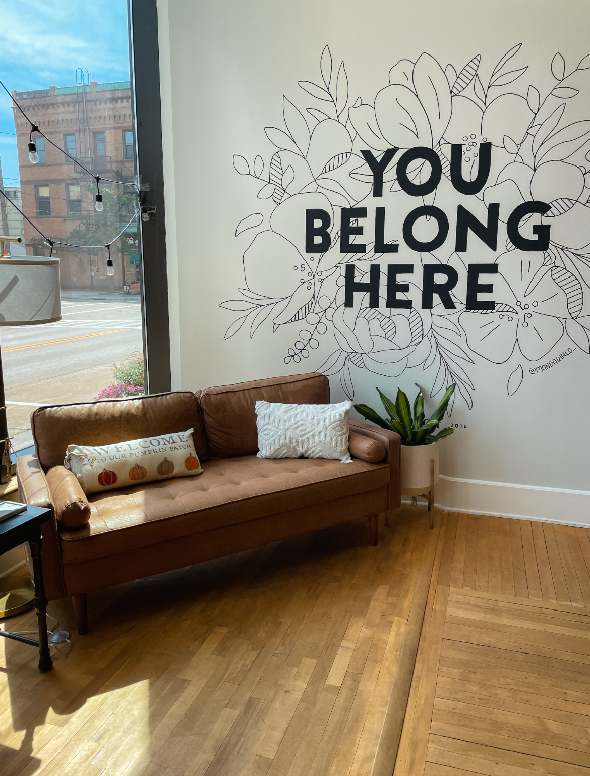 You Belong Here mural and couch at graced