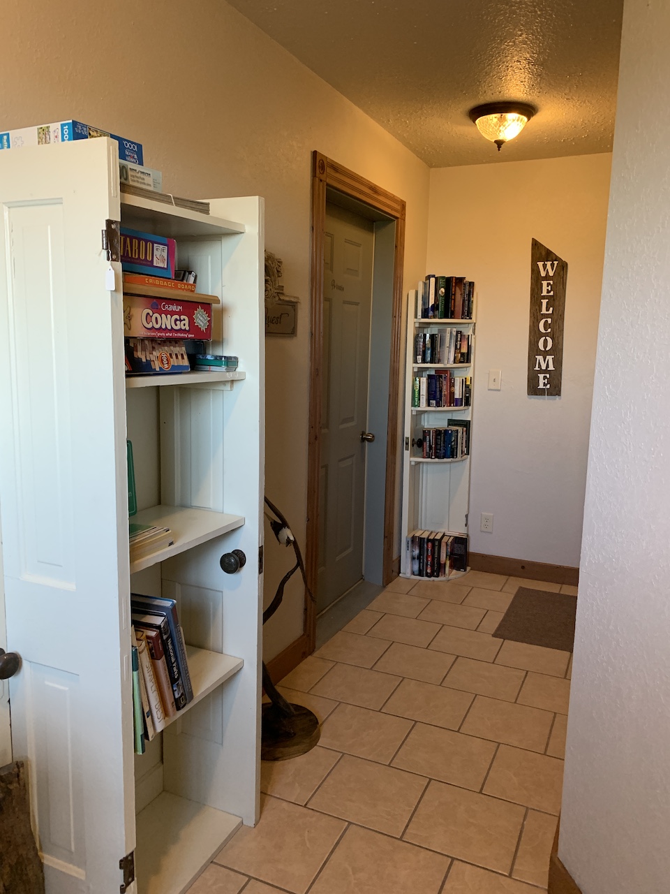 The hallway to the apartment features, books, games, brochures, etc.