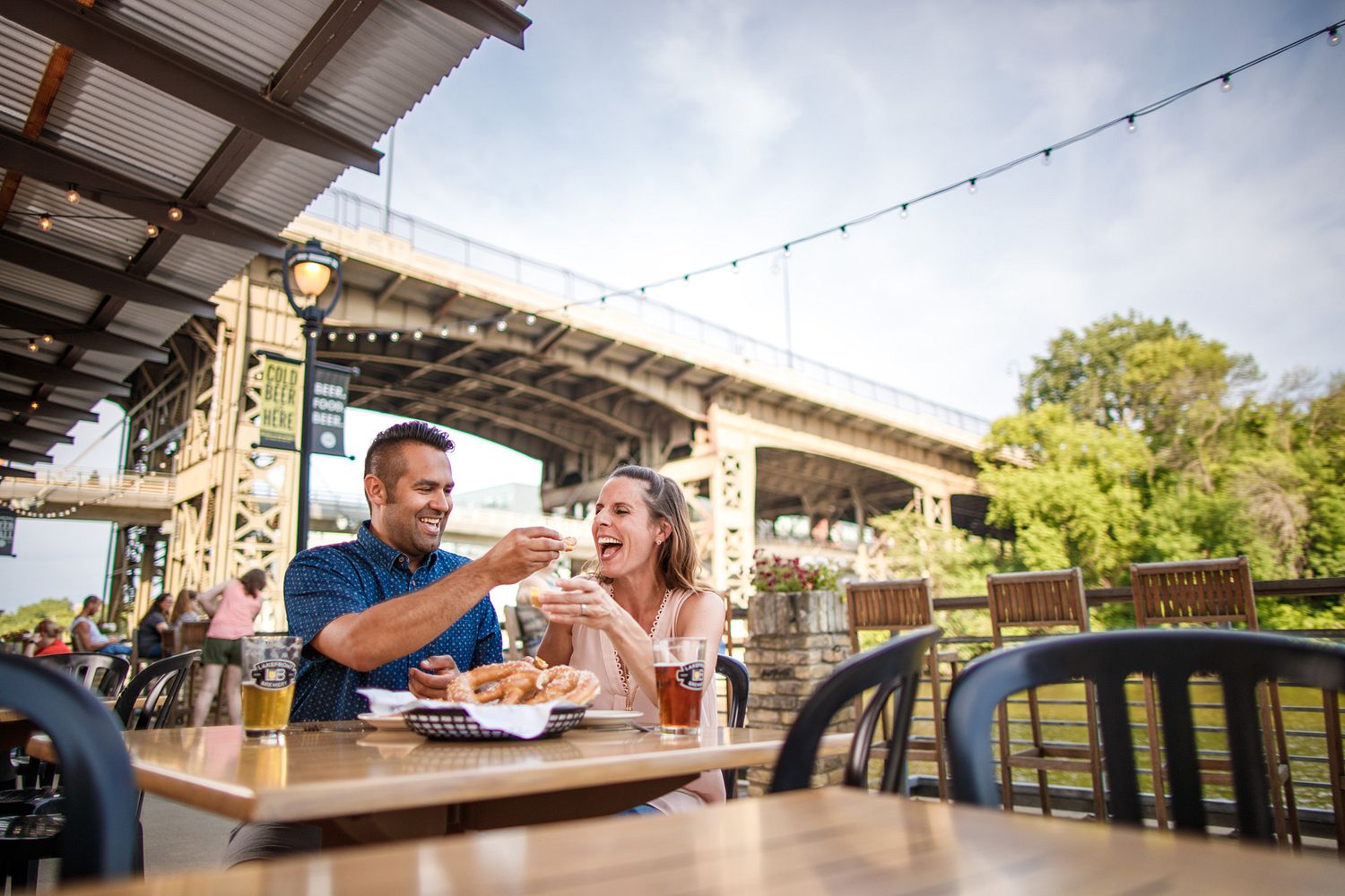 Couple Sharing food on outdoor patio.