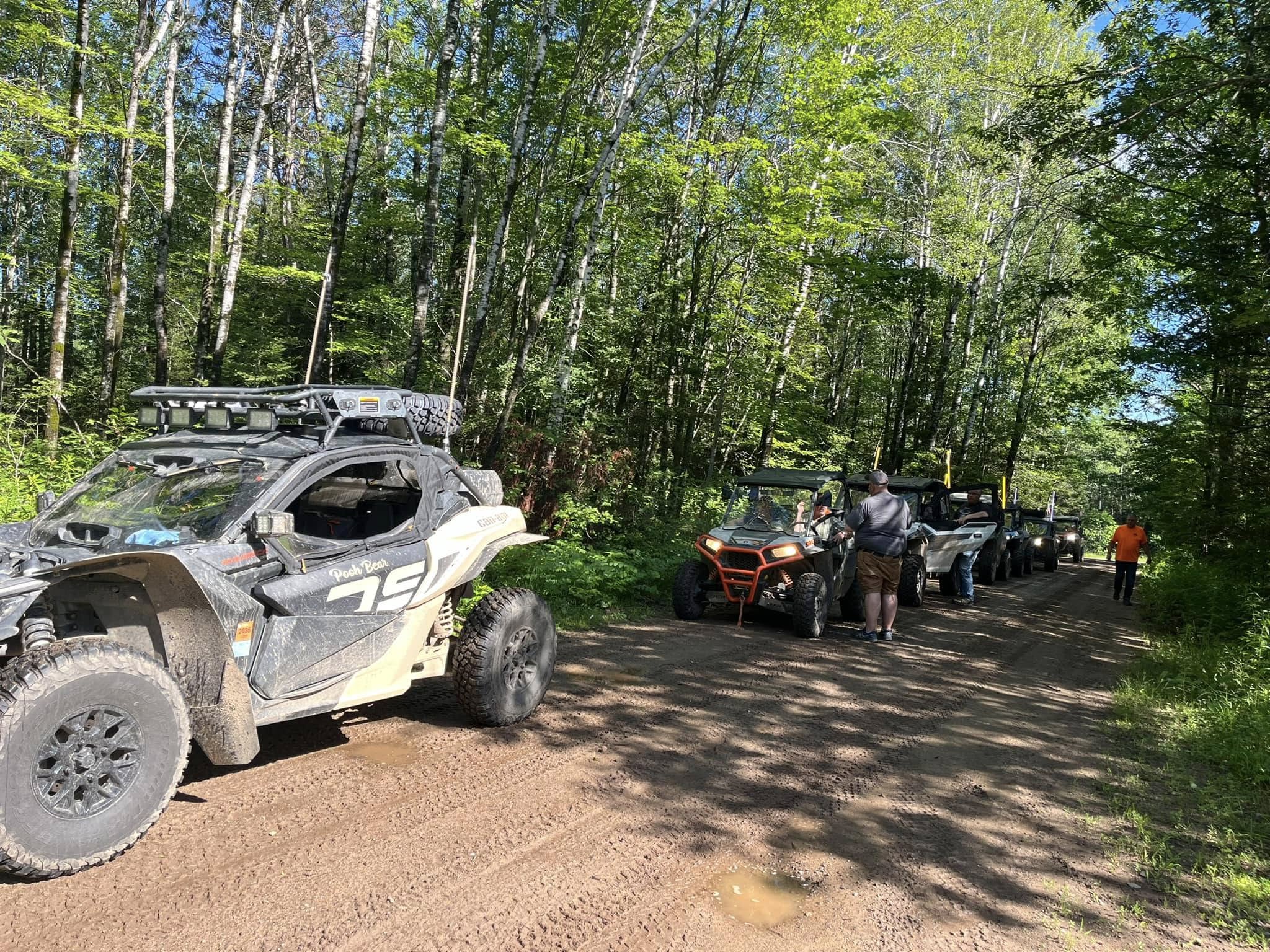 A group of UTV riders pauses for a break along the Pickerel/Pearson ATV Trail, enjoying the fresh air and scenic surroundings of Langlade County’s Northwoods..
