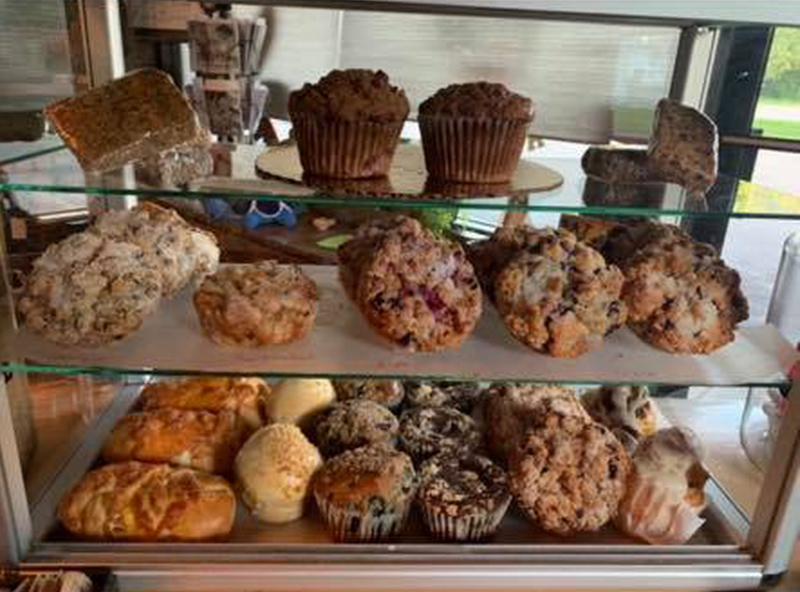 A tempting pastry case at The Brown Mug Coffee and Espresso is filled with fresh-baked goods, including muffins, scones, and sweet rolls—offering the perfect treat to pair with your morning coffee or afternoon pick-me-up in Antigo.