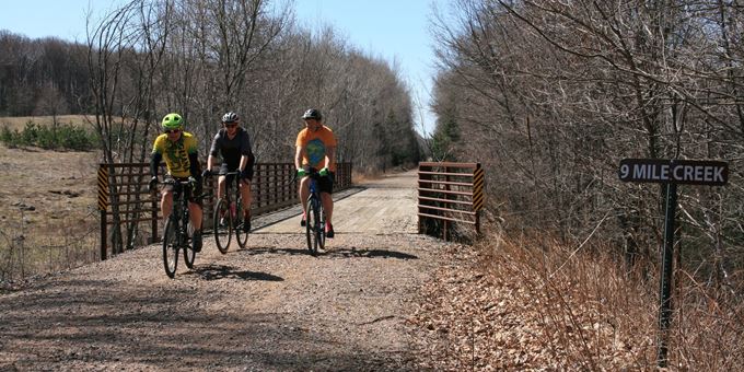 Biking over one of the bridges on the Wolf River State Trail.