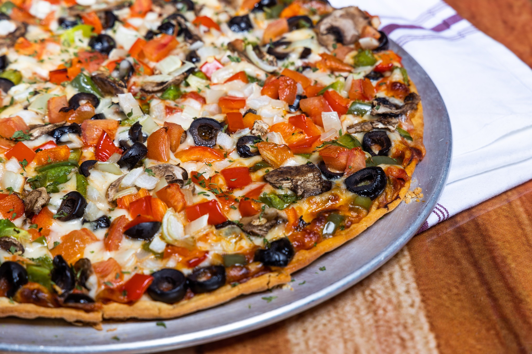 Close-up of a veggie-topped pizza.