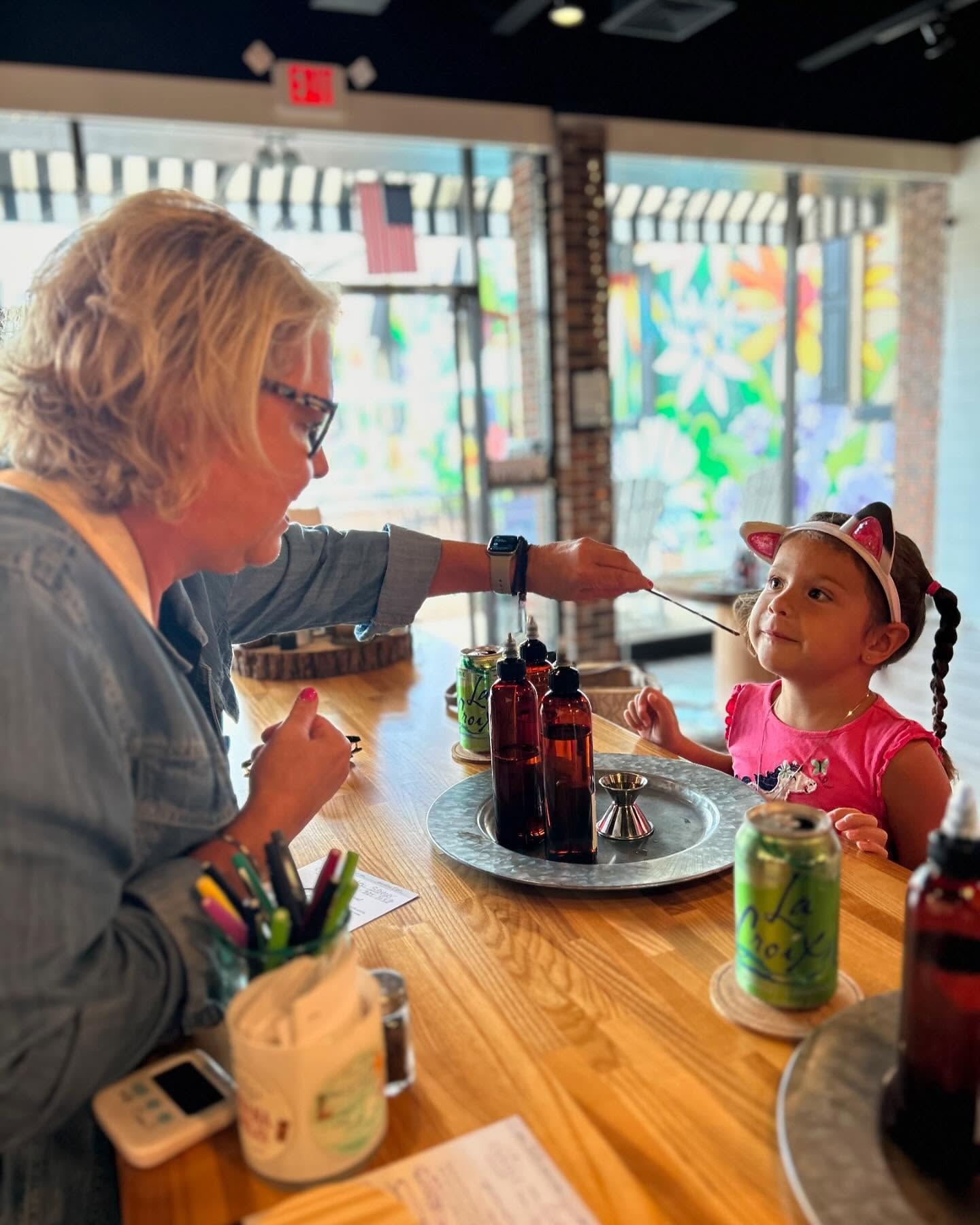 Child learning how to pour a candle.