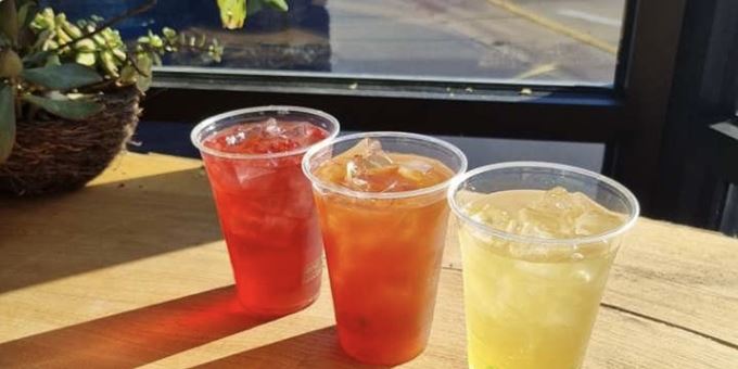 Three colorful drinks in the window at Magpie Gelato