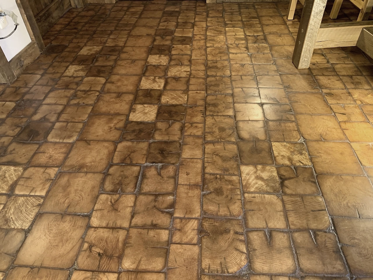 Check out this unique floor made with wood tiles. We cut tiles from the ends of barn beams, like slicing a loaf of bread. Can you say, "unique"?