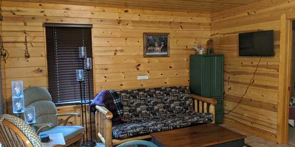 In addition to the full size beds in the bedrooms, the living room holds a full size futon. Although the cabin has no television reception, we do have a television with a built-in DVD player. The cabin also has an air conditioner and electric heat.