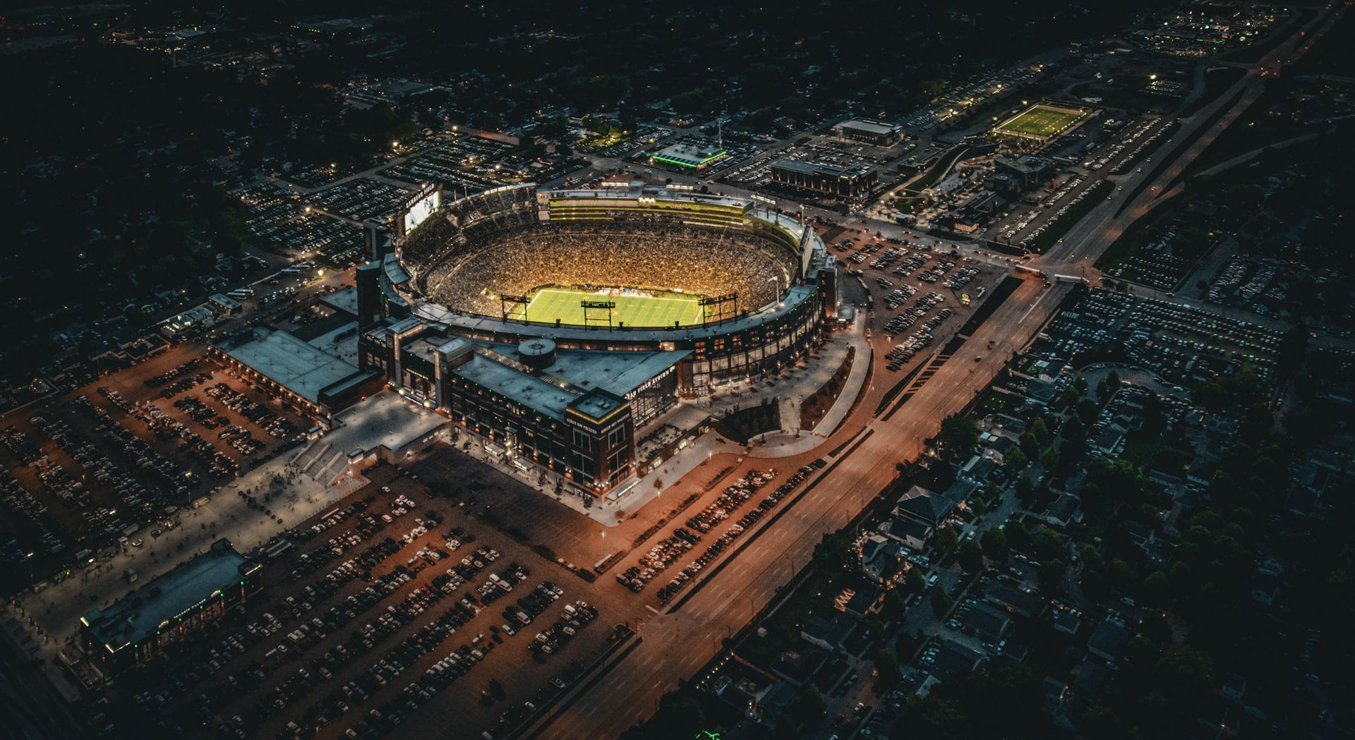 Aerial view of Lambeau Field at night on game day.