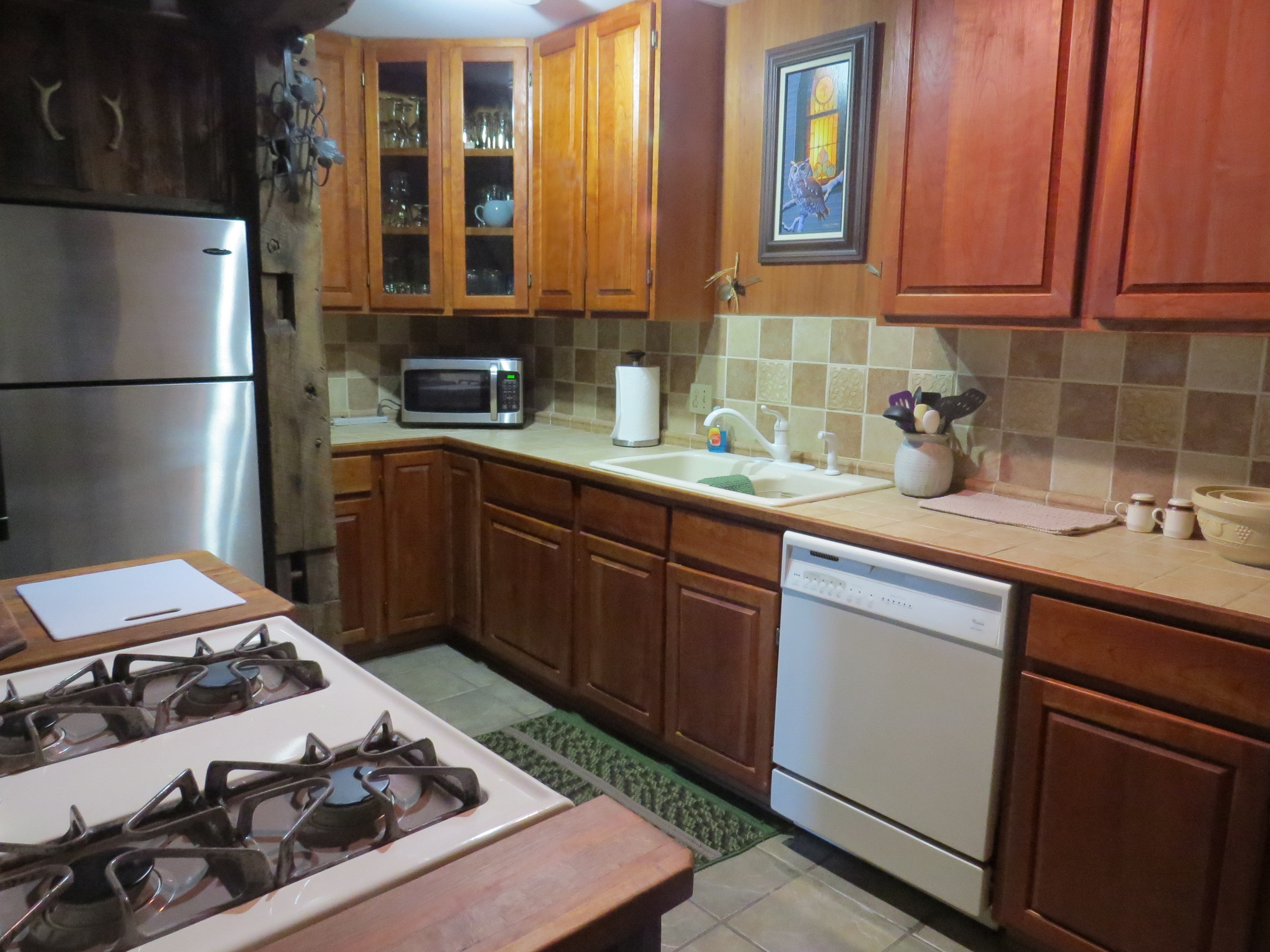 Antique Unit kitchen with gas stove and dishwasher.