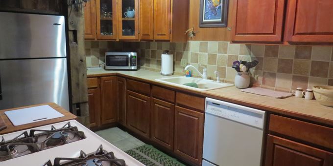 Antique Unit kitchen with gas stove and dishwasher.