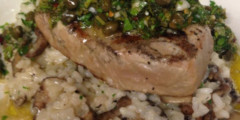 Grilled mahi mahi topped with salsa verde on wild mushroom risotto.