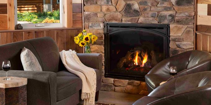Fireplace with leather loveseat and chairs inside the Sunrise Cottage at Justin Trails Resort.