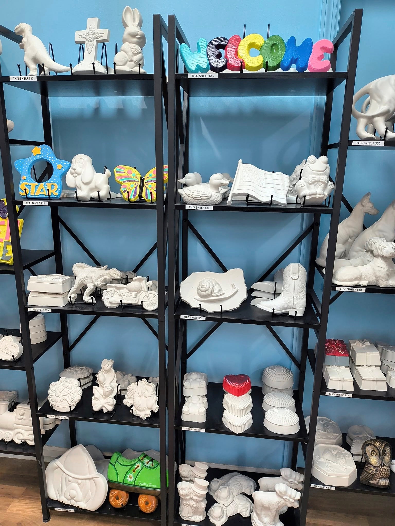 Shelves full of art pieces ready to paint.