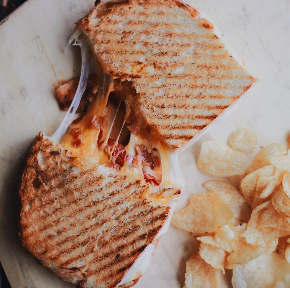 This grown-up grilled cheese is the perfect trio of provolone, cheddar, &amp; mozzarella cheese; roasted tomato &amp; crispy bacon on our made from scratch bread!