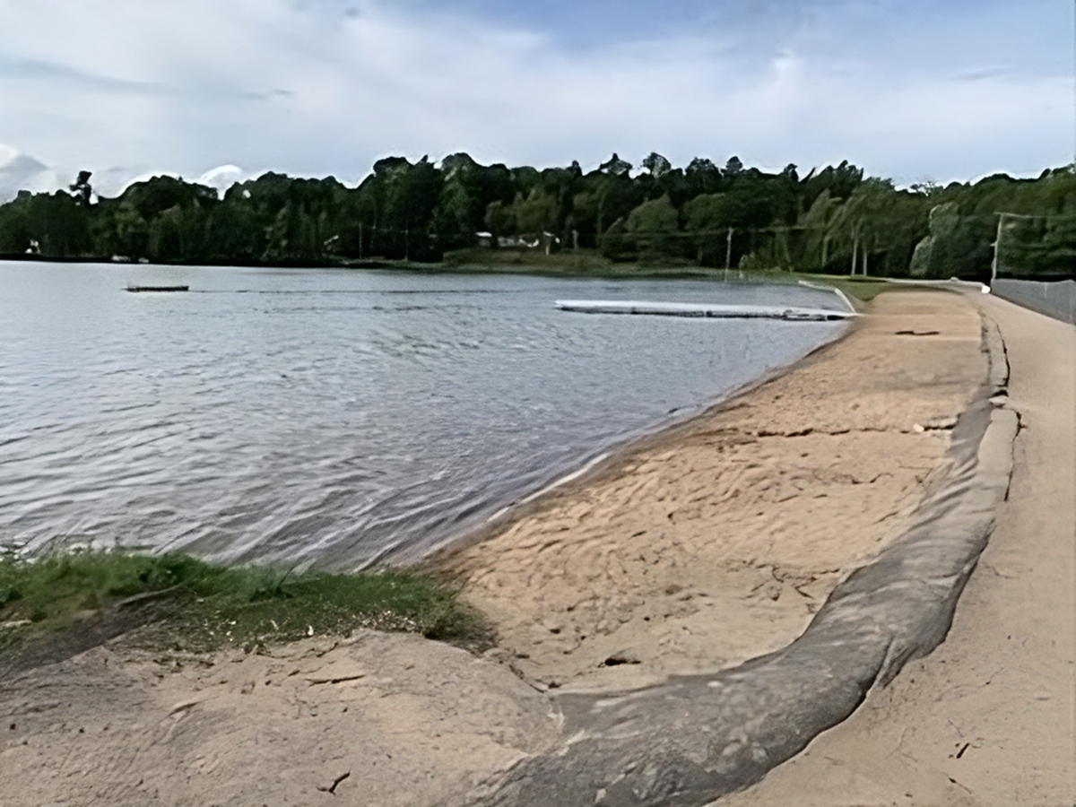 A tranquil view of White Lake Park’s beach showcases calm waters, soft sand, and the peaceful beauty of this lakeside escape in the Village of White Lake.