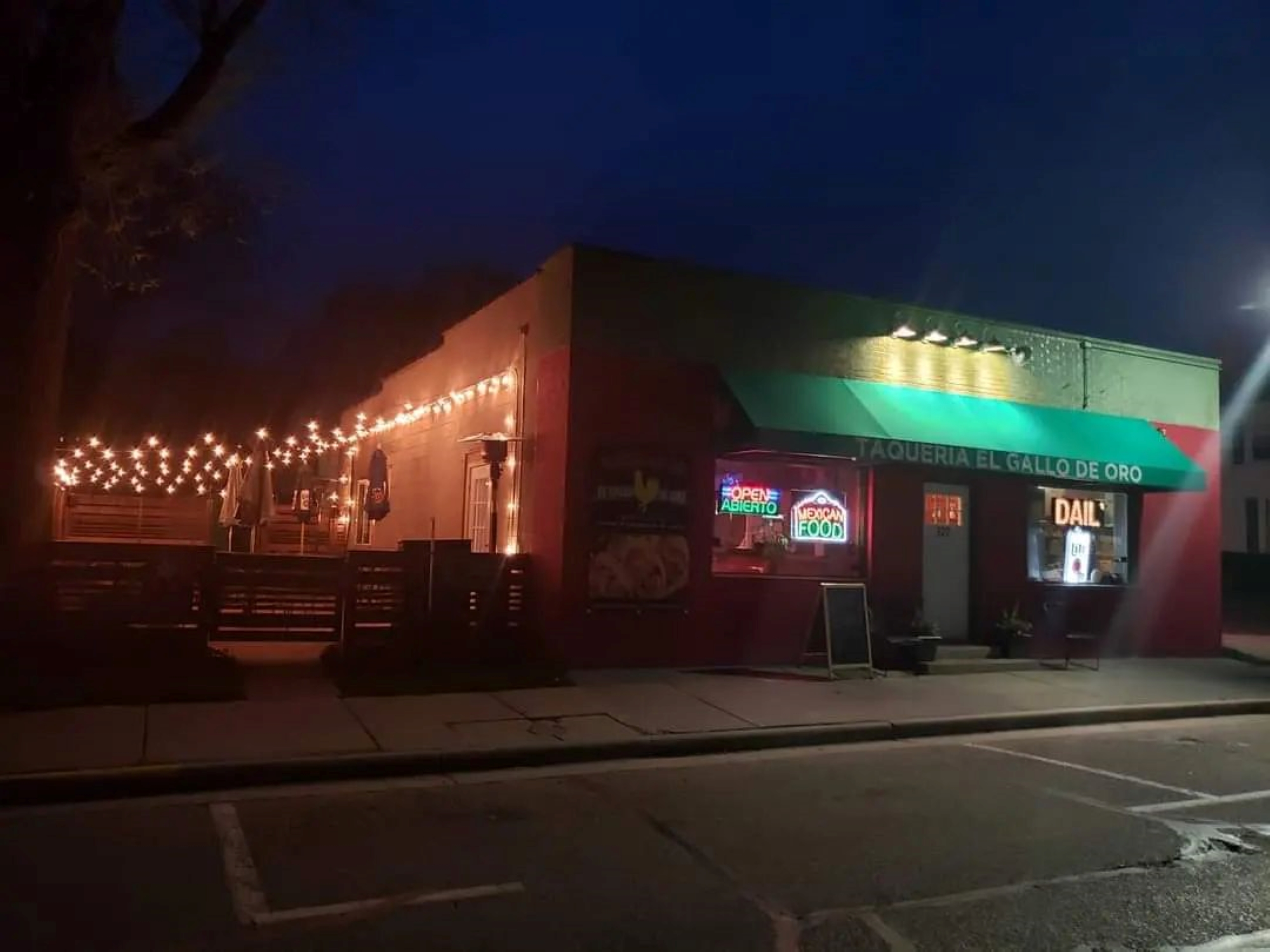 Taqueria El Gallo de Oro at night with a lighted patio space.