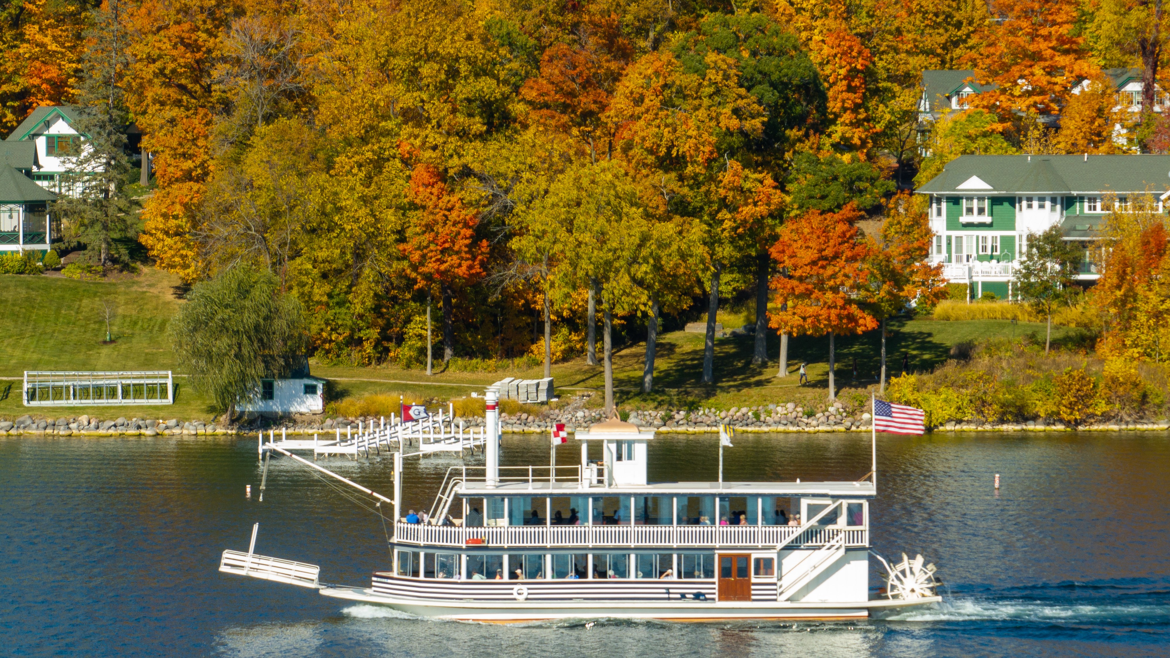A cruise boat out on the lake with fall colors