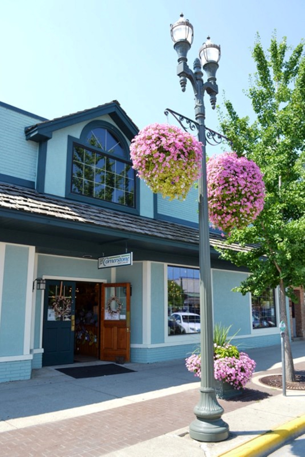 Entrance to the Cornerstone Shoppe with summer flowers in the basket.