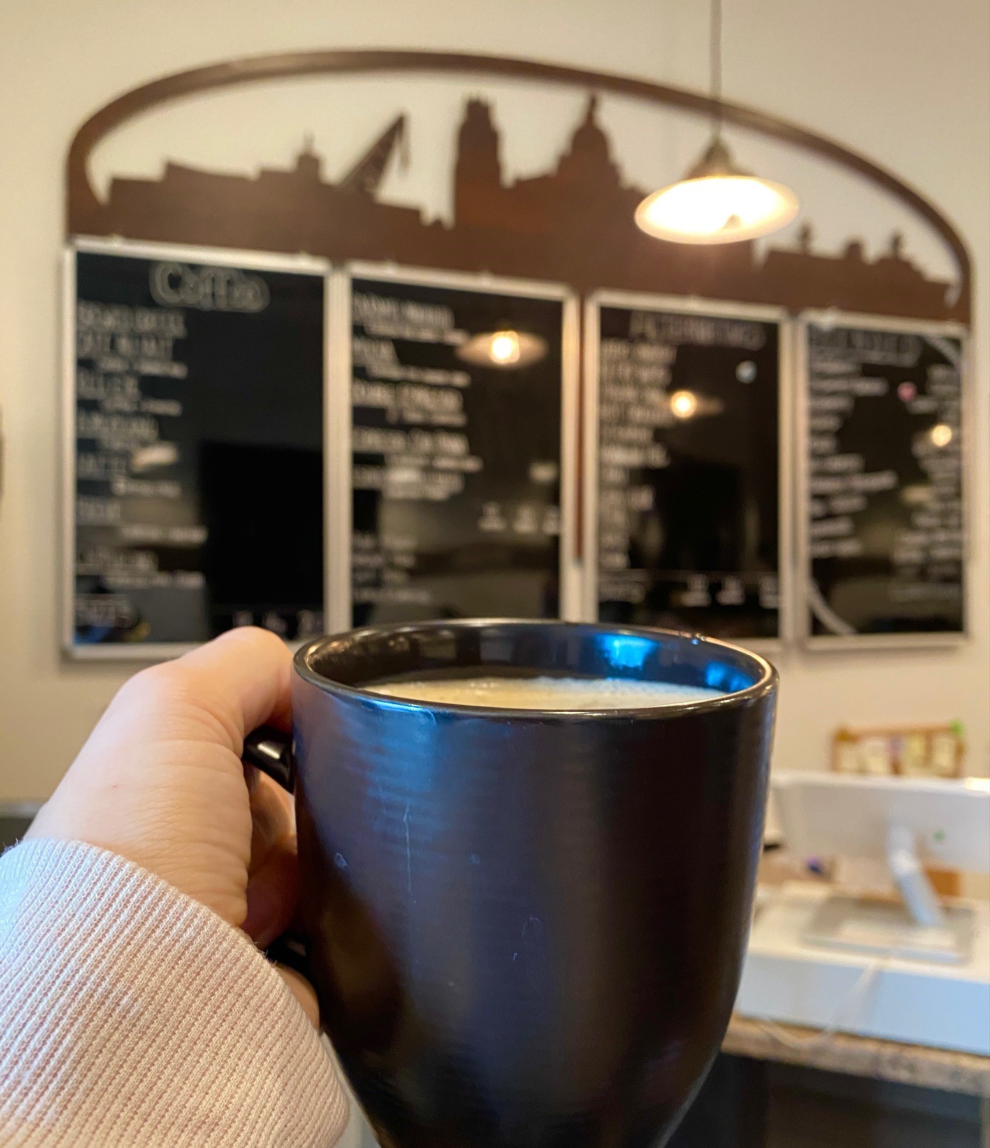 Latte in front of menu board