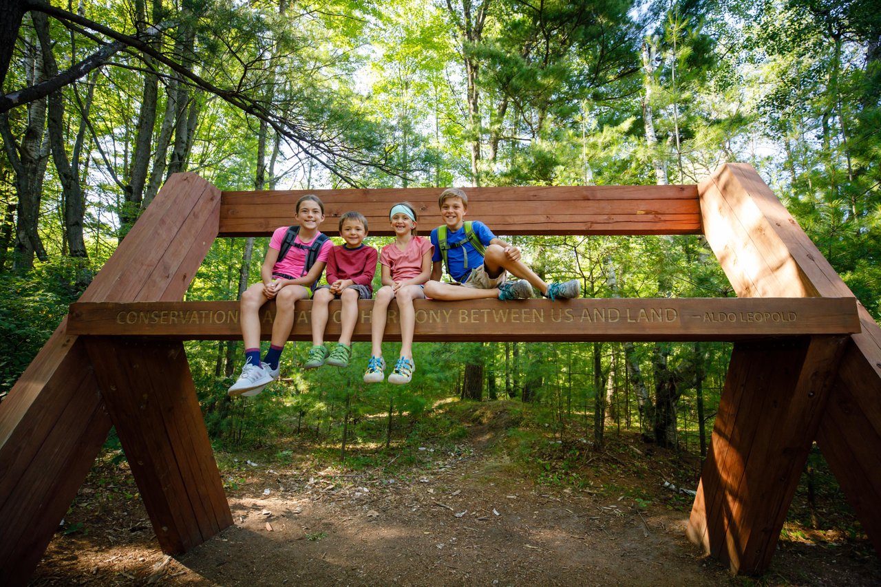 Kids on top of the giant bench at the Stevens Point Sculpture Park