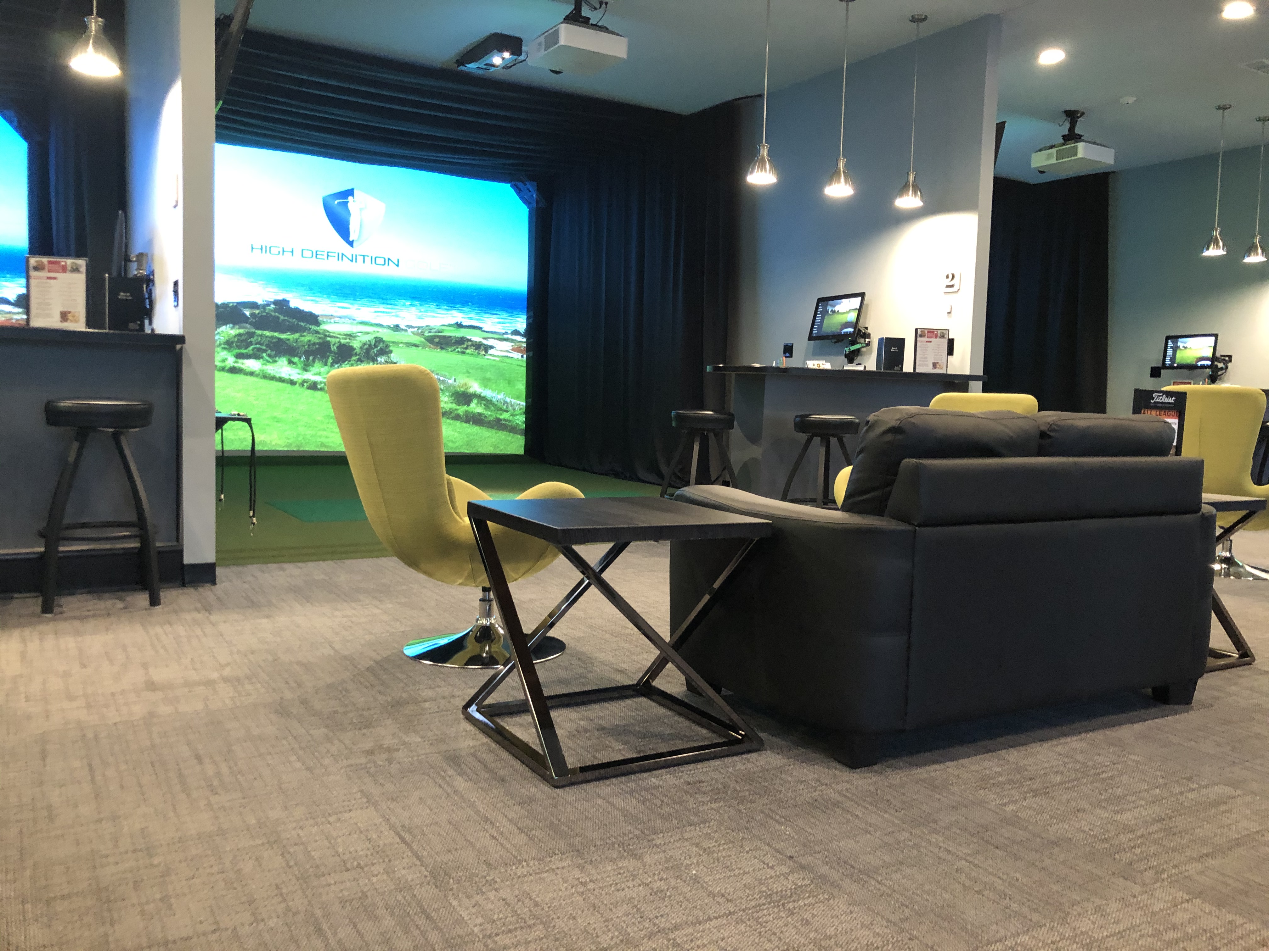 6 High Definition Golf Simulators in modern setting with complete food and beverage service