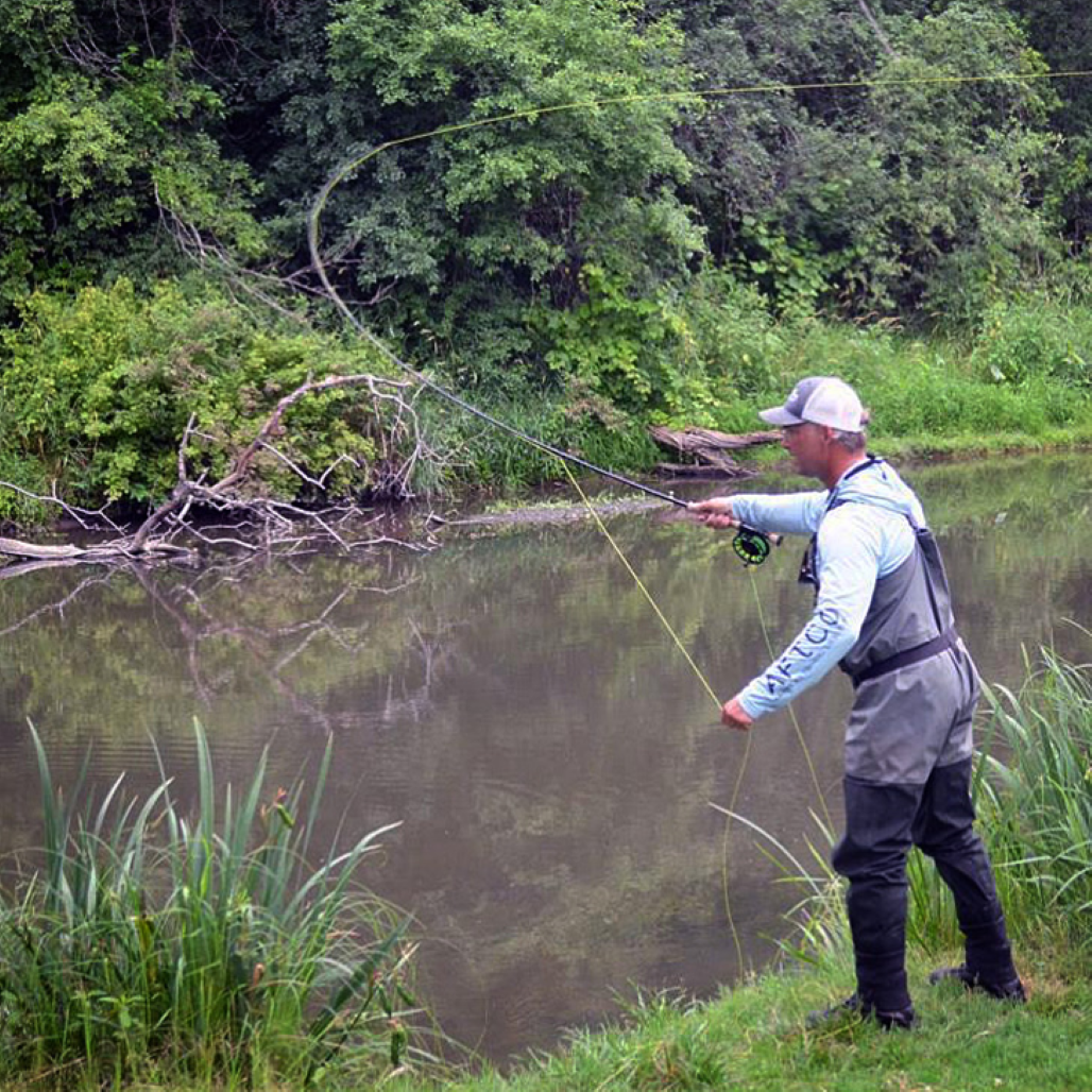 Fisherman casting into a river.