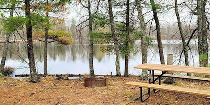Shoreline and picnic table at Perch Lake Campground.