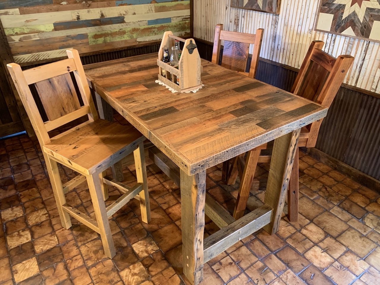 One of many pieces of furniture in our ever-changing inventory. This is a pub height table made with reclaimed wood and barn beams for legs