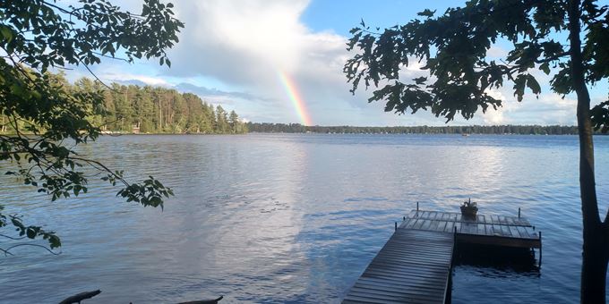 A rainbow over a dock on Post Lake, near the dam.